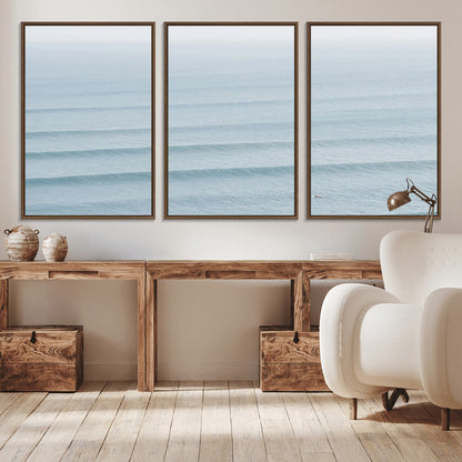 Framed canvas of repeating ocean waves with a distant solo surfer, ideal for minimalist ocean or calm coastal wall decor.