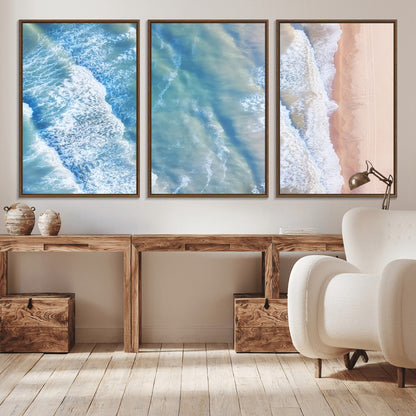 Aerial photo of soft blue waves meeting sandy shore, perfect for modern coastal or beach-themed decor with a light and tranquil aesthetic.