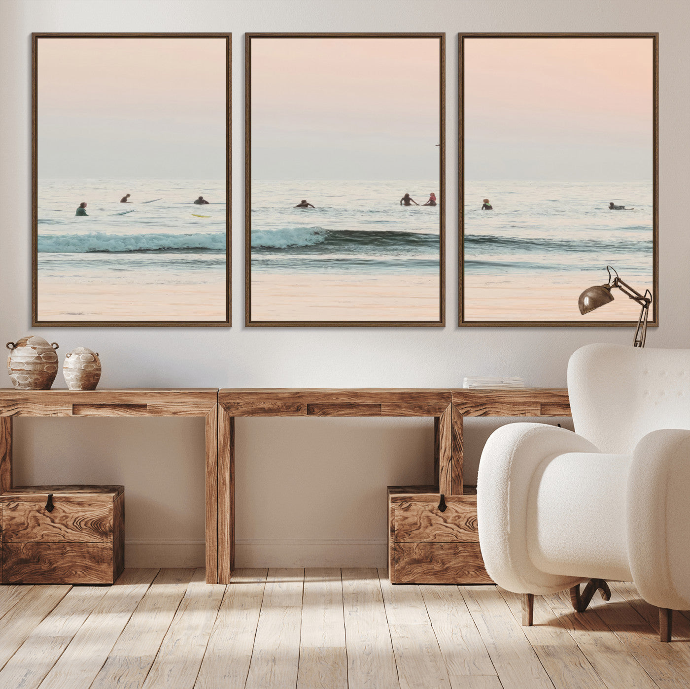 Dreamy photo of surfers waiting on soft pastel waves under a pink sunset sky, ideal for soft coastal minimalist or serene ocean-themed home decor.