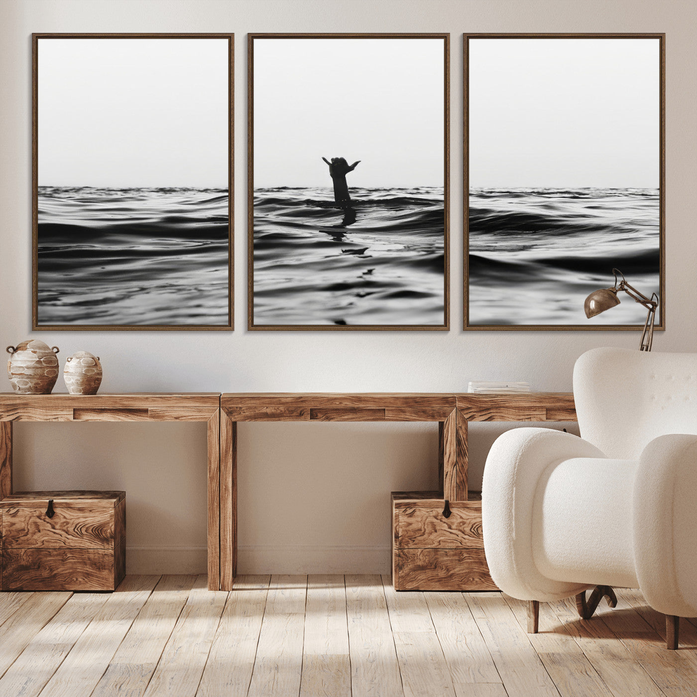 Black and white ocean with a hand making a surfer sign among dark waves, creating a dramatic and minimalist seascape with bold contrast.