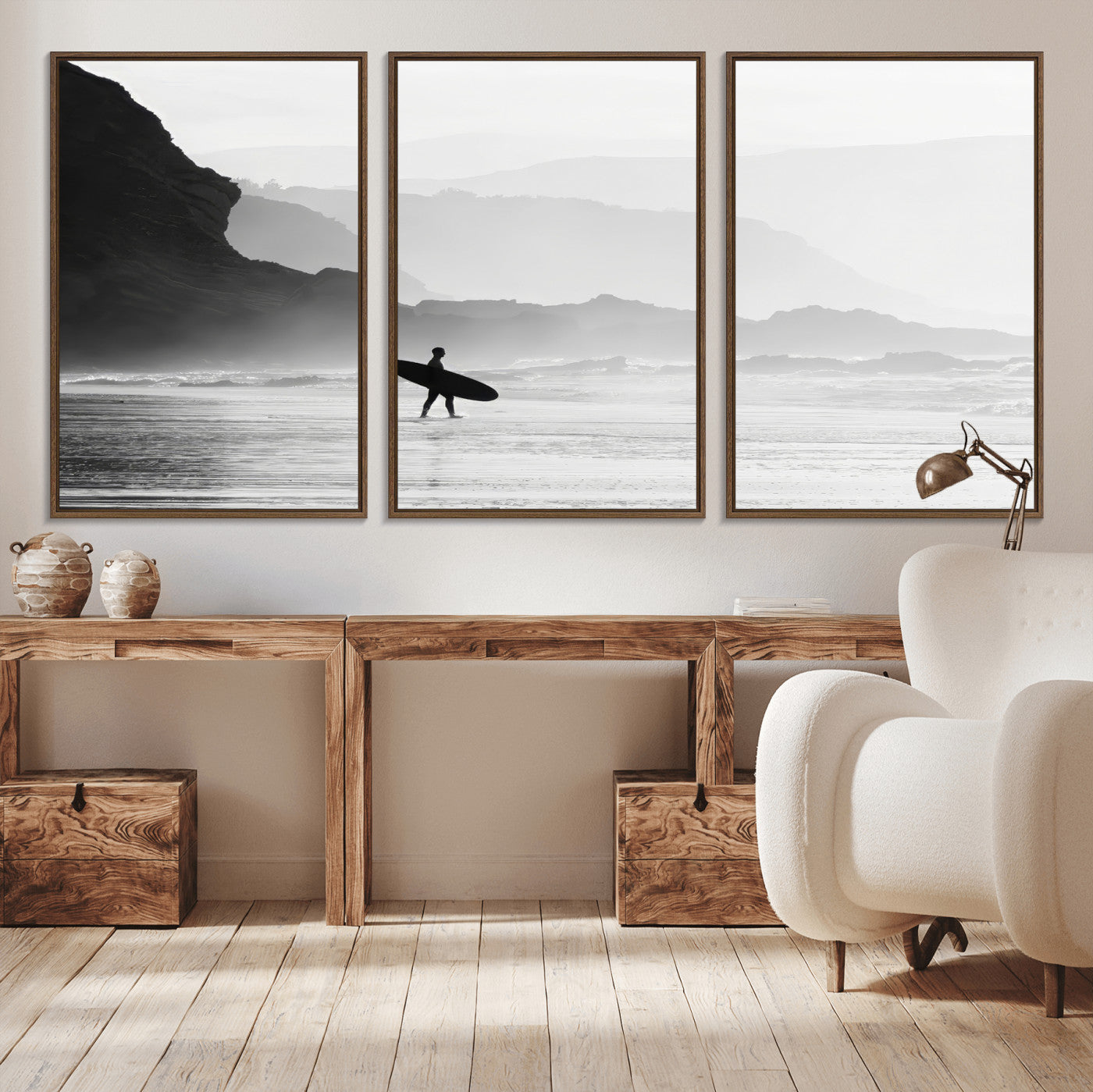 A lone surfer walking along a misty beach with cliffs in the background, carrying their board, capturing a serene and minimal ocean moment.