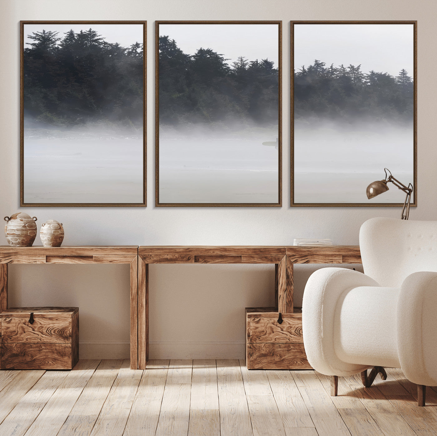 A lone surfer carrying a board through a misty shoreline, surrounded by dense trees and fog, creating a peaceful and mysterious coastal scene.