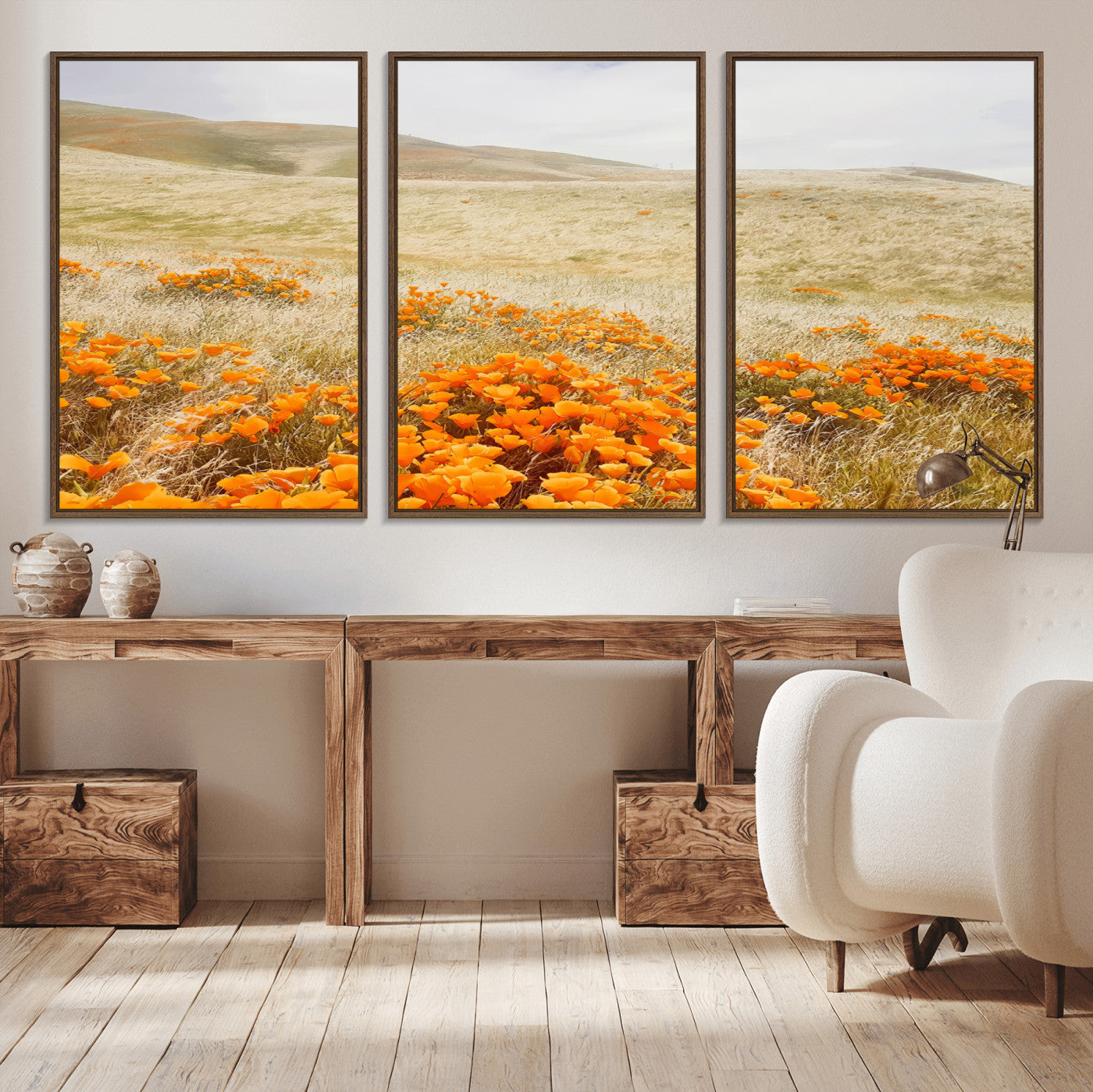 A golden field with vibrant orange poppies blooming across rolling hills under a soft, sunlit sky, creating a warm and rustic landscape.