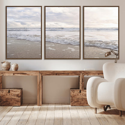 Peaceful ocean waves rolling onto the sandy shore under soft light, perfect for neutral or coastal minimalist decor themes.