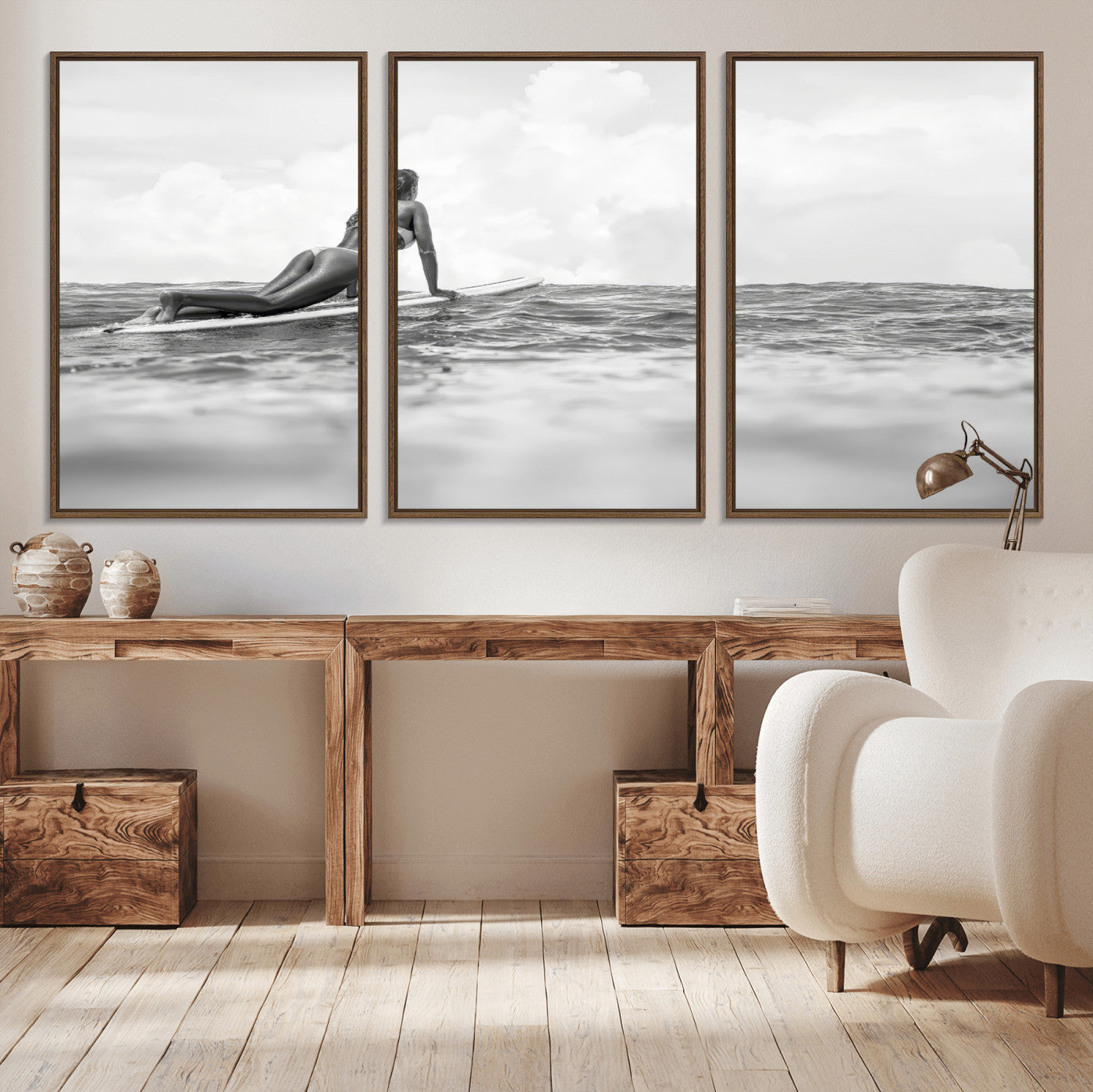 A black and white ocean scene featuring a surfer girl waiting on her board, gazing at the horizon, capturing a tranquil and adventurous coastal moment.
