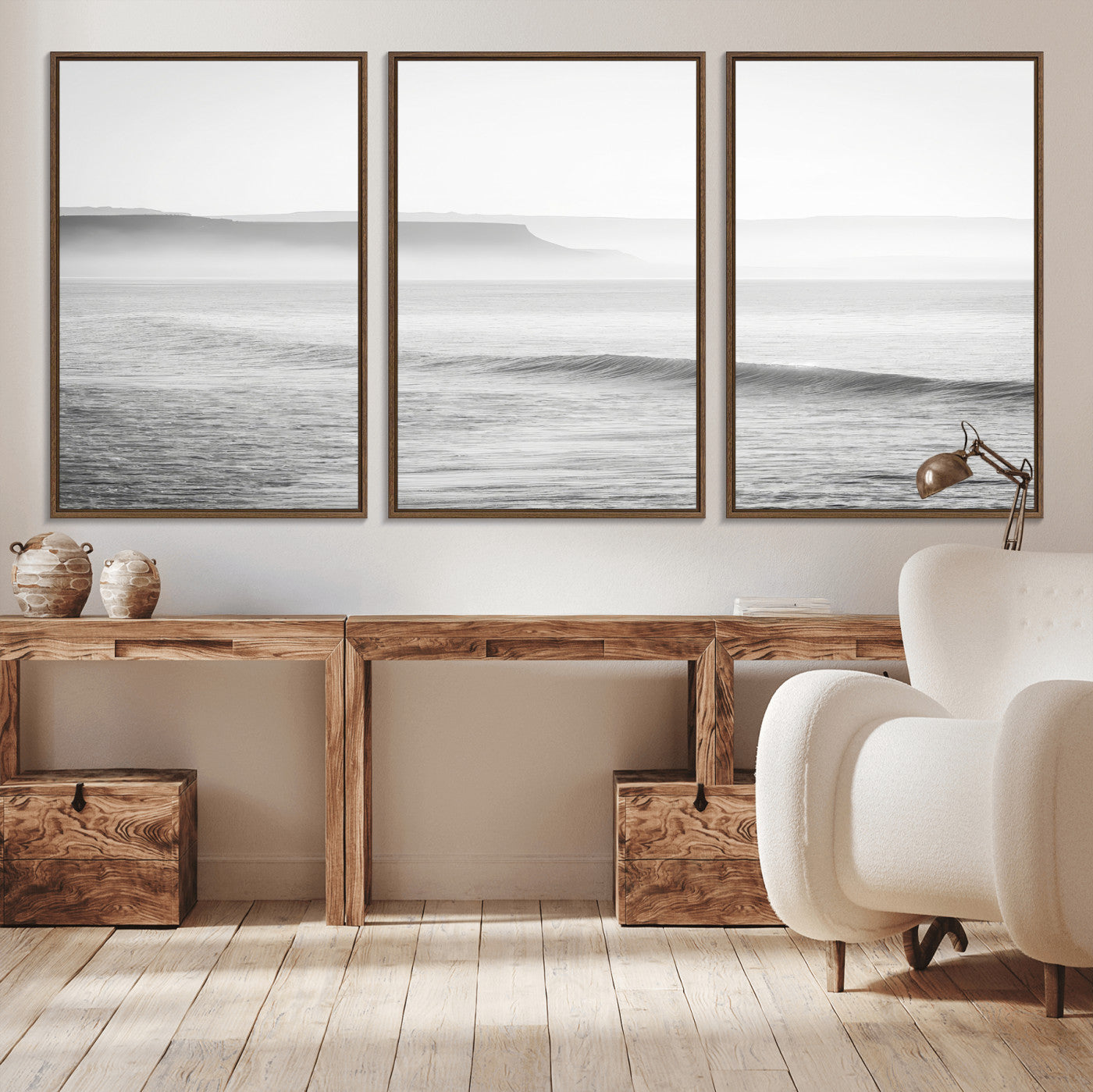 A black and white minimalist seascape featuring soft rolling waves and misty distant cliffs, creating a serene and timeless coastal atmosphere.