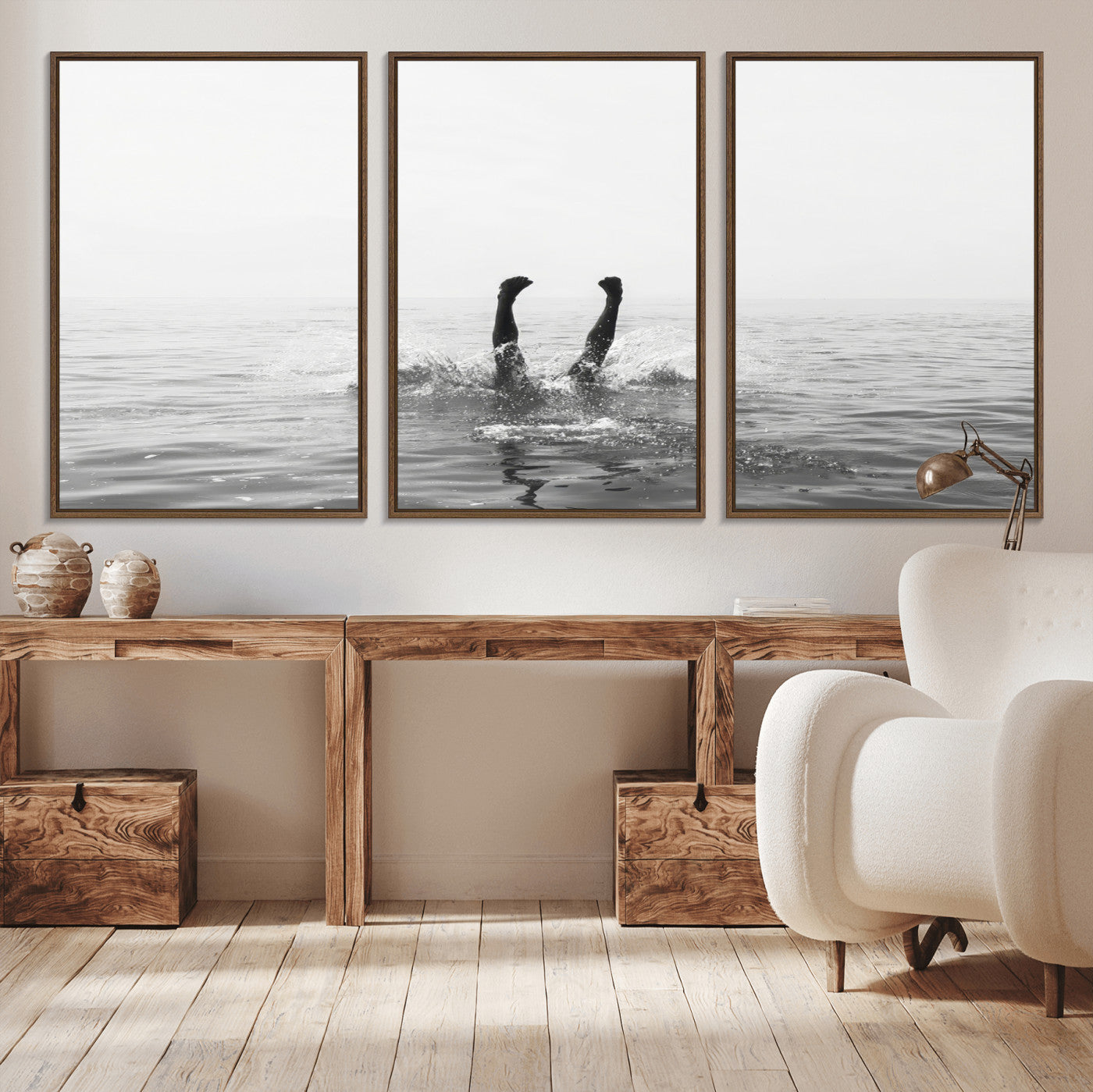 A black and white minimalist water scene capturing a playful splash as a swimmer dives upside down, creating a carefree and artistic aquatic aesthetic.