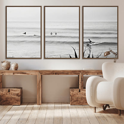 Monochrome canvas of surfers on calm ocean waves, ideal for minimalist coastal or beach-inspired interior decor.