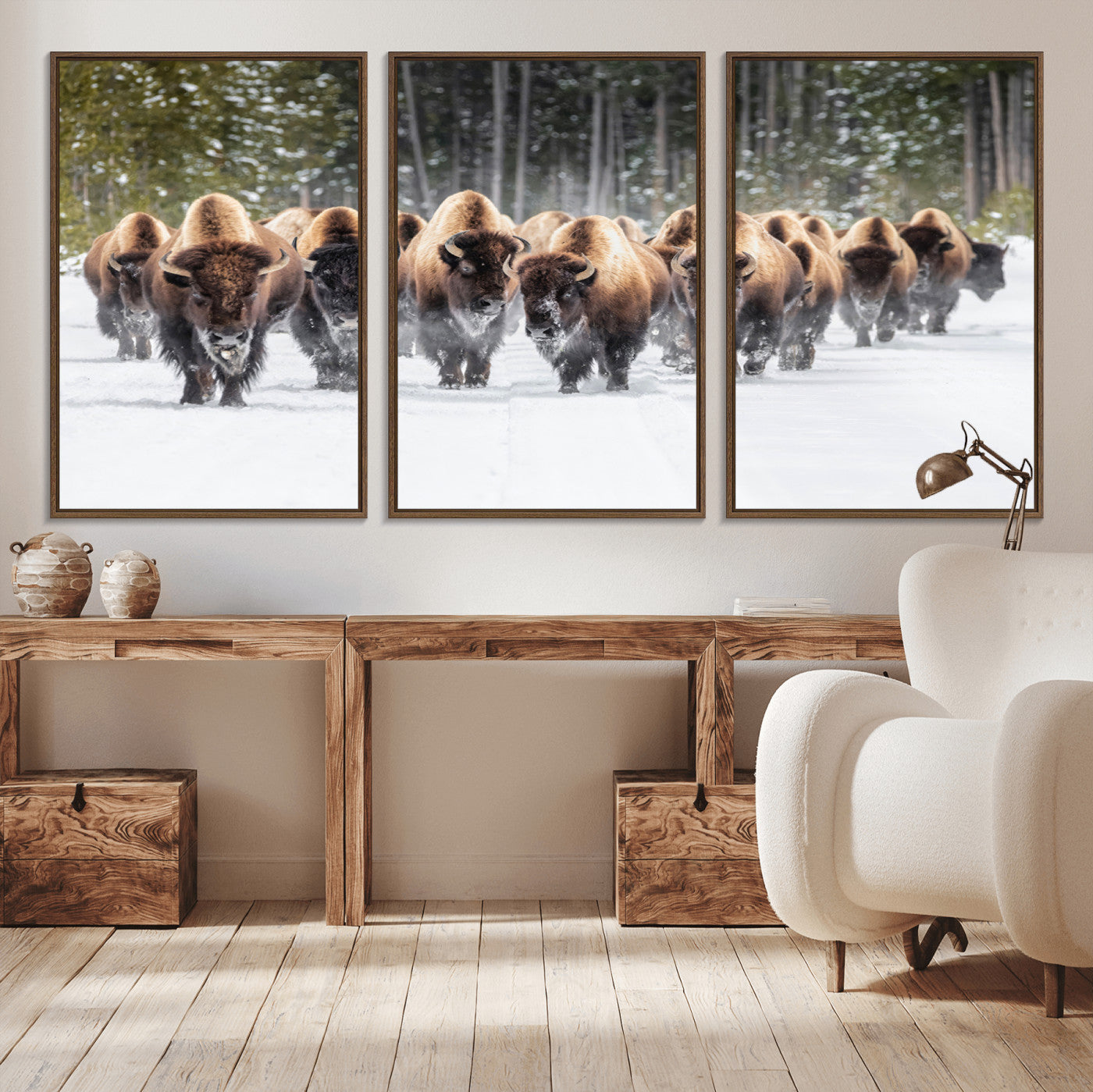 A herd of American bisons walking through a snowy forest path, perfect for rustic cabin or Western-themed wall decor.