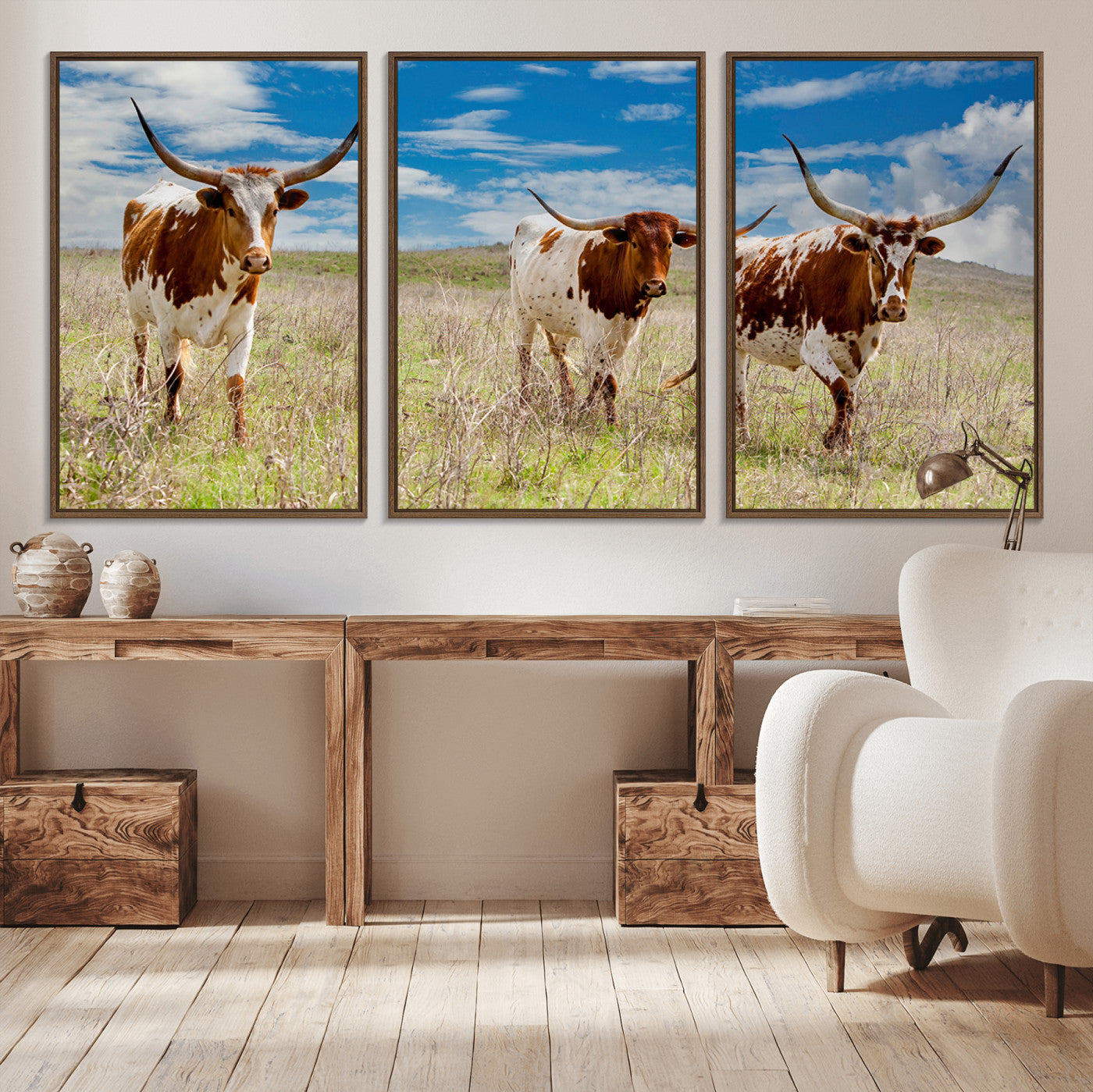 Three Texas longhorn cattle standing in dry grass under a bright blue sky, ideal for farmhouse or western rustic home decor.