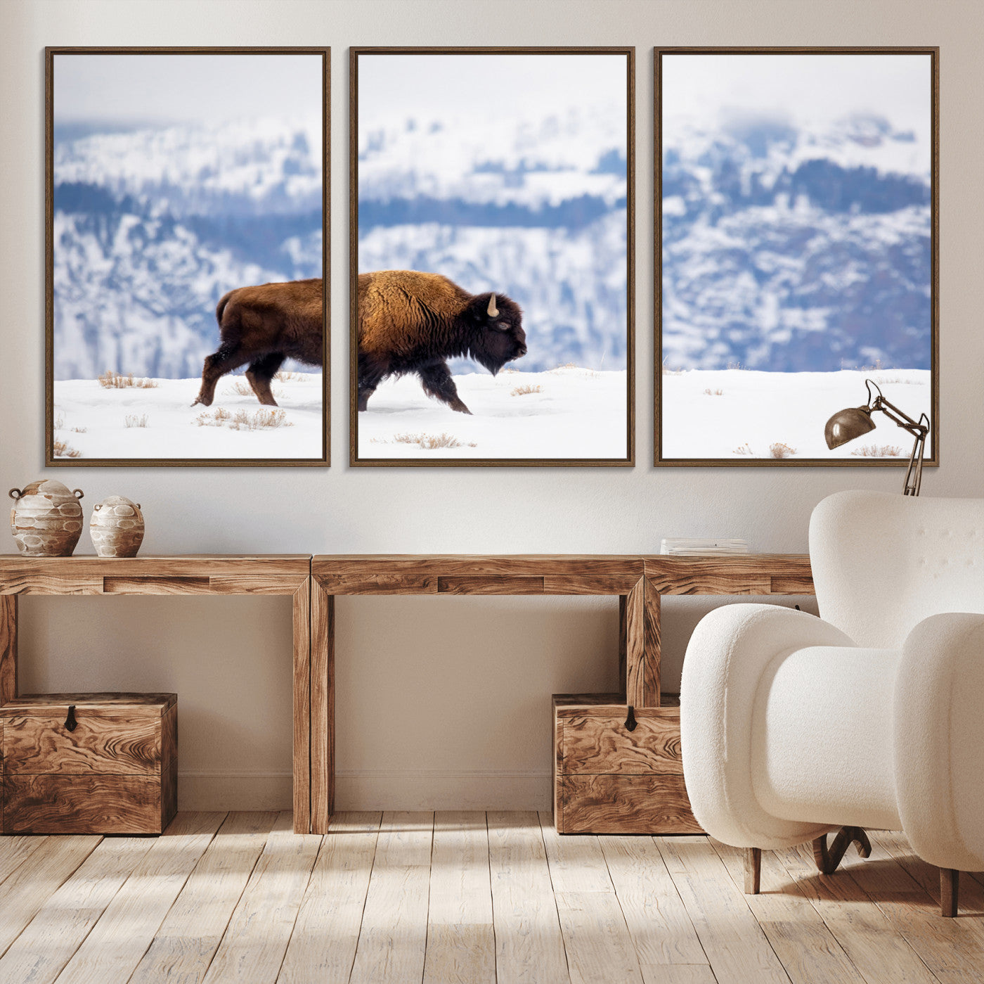 A lone bison walks across snowy ground with blue-toned mountain range behind, ideal for rustic or western farmhouse interiors.