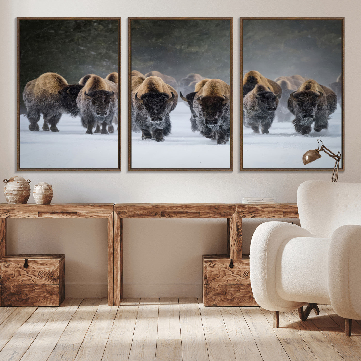 A herd of American bisons walking through deep snow in a forest, evoking a powerful rustic wilderness mood for western-style interiors.