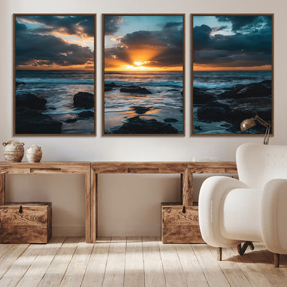 An awe-inspiring sunset over the ocean with rays of light piercing through dramatic clouds, creating a beautiful seascape with rocks in the foreground.