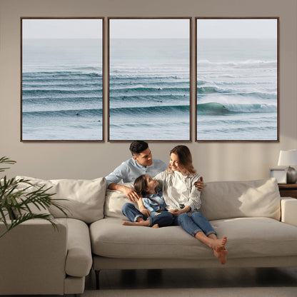 High-angle view of surfers lining up across layered ocean waves, ideal for minimal coastal or surf-inspired room decor.