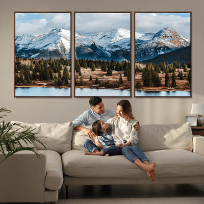 Framed canvas of snowy mountain peaks with pine forest and alpine lake, perfect for winter cabin or wilderness-inspired home decor.