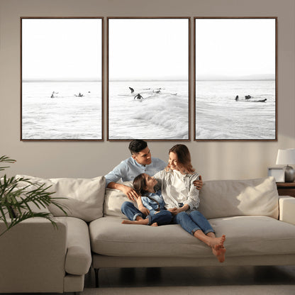 Monochrome photo of surfers riding and waiting on ocean waves, ideal for surf-themed or coastal energy wall decor.