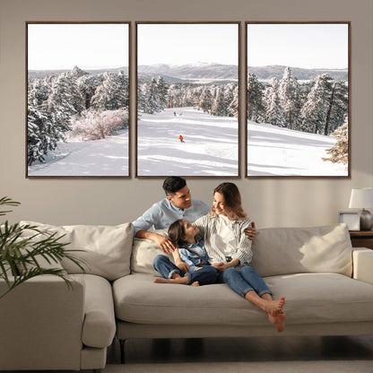 Bright ski trail lined with snow-covered pines and a skier in orange, perfect for alpine adventure or winter sports-inspired decor.