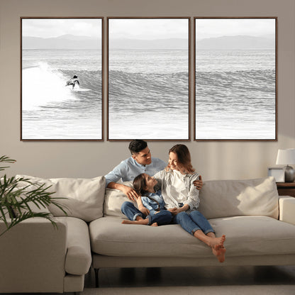 Monochrome photo of a surfer riding a wave with distant mountains, ideal for coastal motion or black and white surf-themed wall decor.