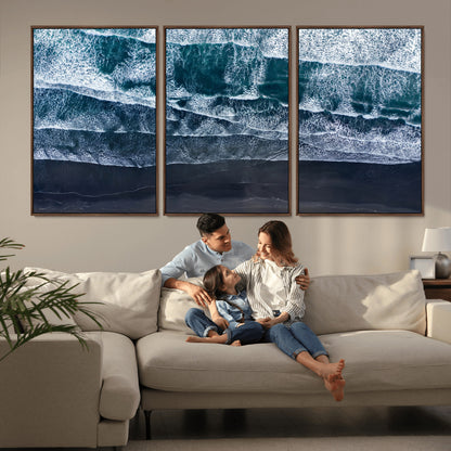 Canvas of aerial ocean waves crashing onto a black sand beach in moody tones, ideal for modern coastal or minimalist home decor.