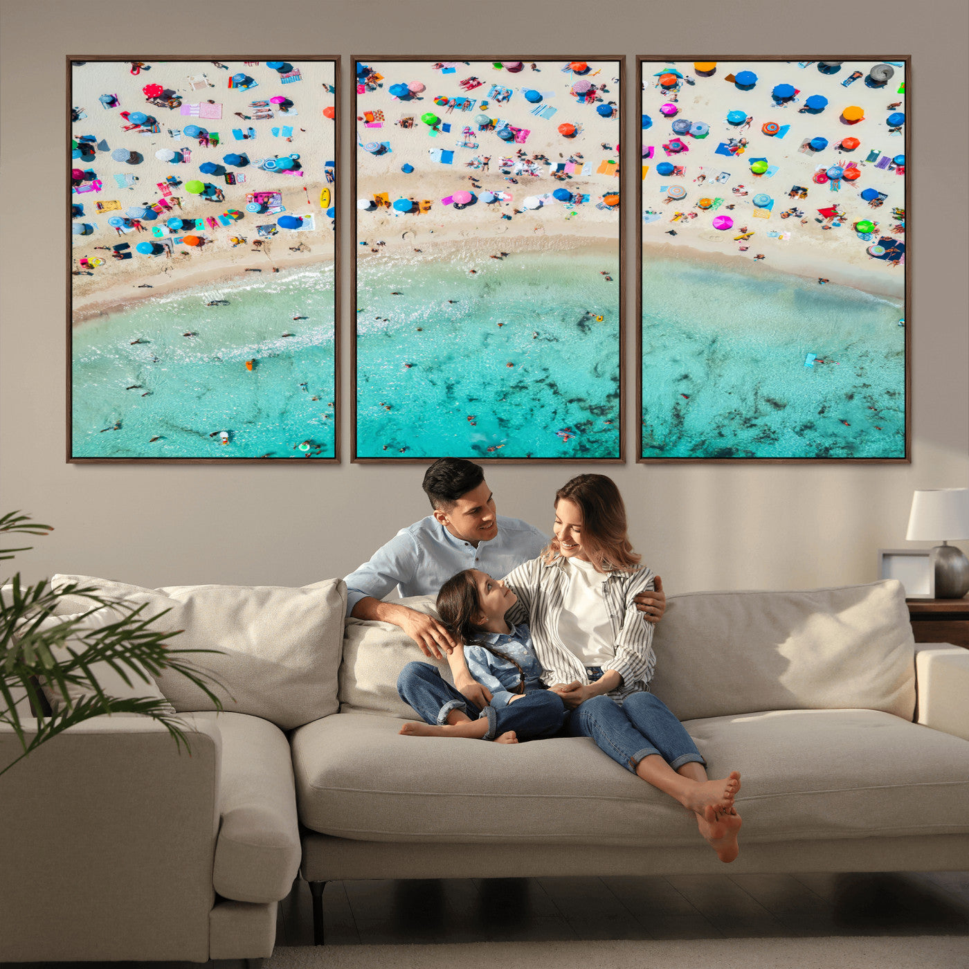 Aerial view of a vibrant beach filled with colorful umbrellas and people enjoying the turquoise ocean, capturing a lively summer vacation scene.