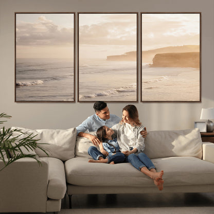 Golden hour seascape with misty cliffs and gentle waves rolling towards the shore, capturing a tranquil and warm coastal atmosphere.