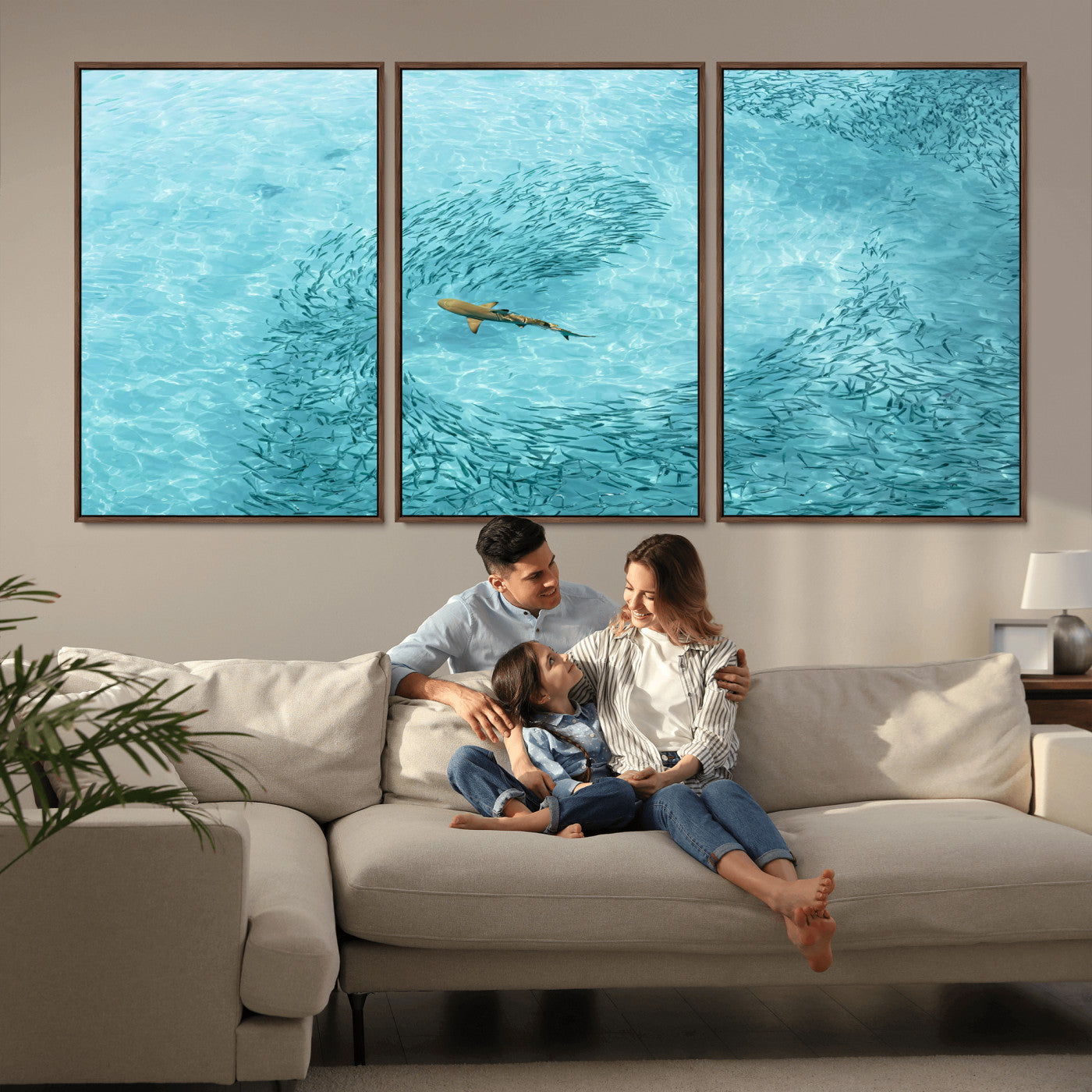 Aerial view of a shark swimming through a swirl of fish in clear turquoise waters, perfect for calm coastal or beach house decor.