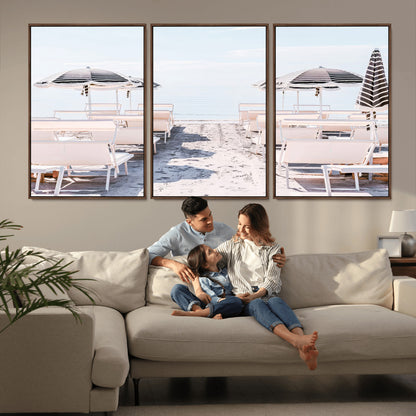 A serene minimalist beach scene featuring striped umbrellas, soft pastel sand, and an elegant lounge setup, creating a tranquil and stylish coastal retreat.