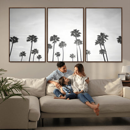 A black and white minimalist scene featuring tall palm trees silhouetted against a bright sky, creating a dreamy and timeless tropical aesthetic.