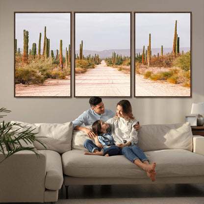 A desert road lined with saguaro cacti under a golden sky, creating a warm southwestern feel, perfect for boho or rustic decor.