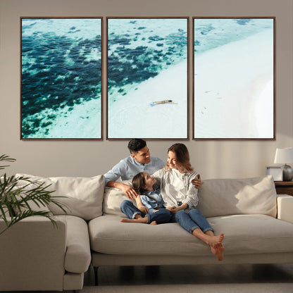 Canvas featuring an aerial view of a swimmer in shallow turquoise waters with coral patterns, ideal for tropical coastal home decor.