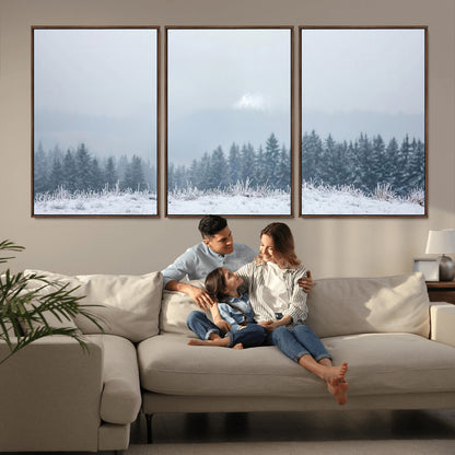 Snow-covered forest under misty sky, soft light breaking through clouds, ideal for minimalist or Nordic-inspired home decor.
