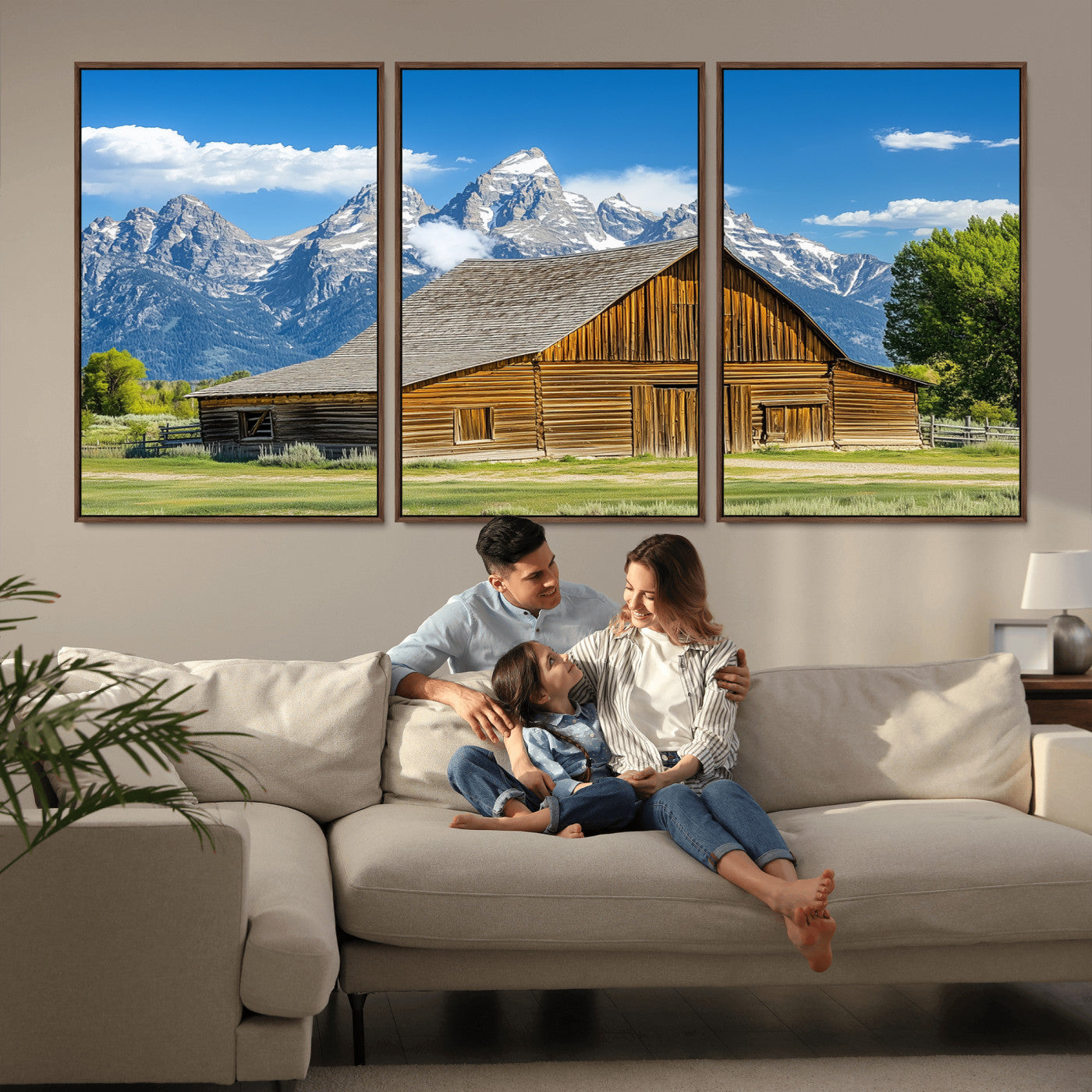 A rustic wooden barn sits in front of towering mountain peaks under a clear blue sky, perfect for farmhouse or cabin style interiors.