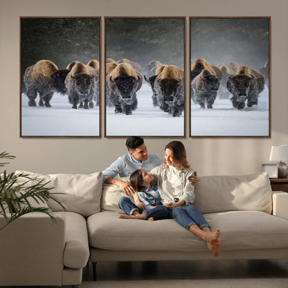 A herd of American bisons walking through deep snow in a forest, evoking a powerful rustic wilderness mood for western-style interiors.