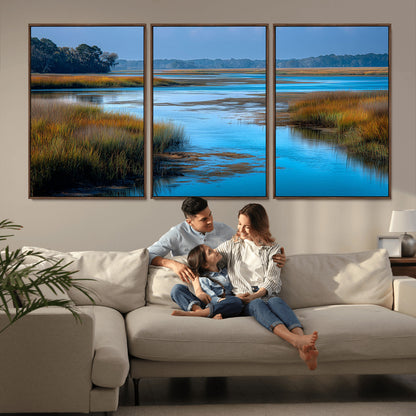 A peaceful marshland scene with calm blue water reflecting the surrounding grasses and trees, capturing the beauty of nature in a serene landscape.