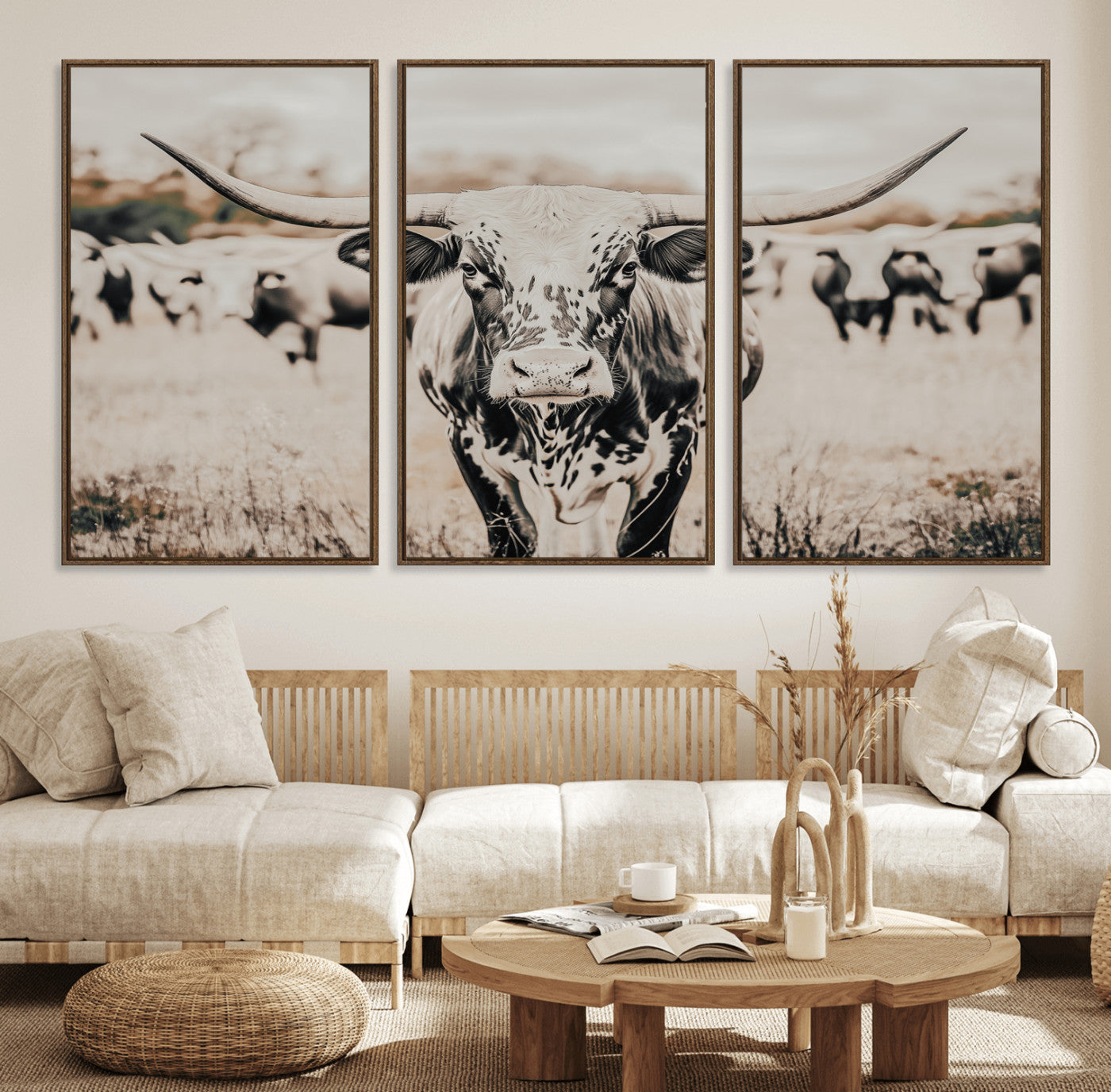 Canvas of a speckled Texas longhorn standing boldly in a field with a herd behind, perfect for rustic western or farmhouse wall decor.