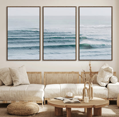 High-angle view of surfers lining up across layered ocean waves, ideal for minimal coastal or surf-inspired room decor.