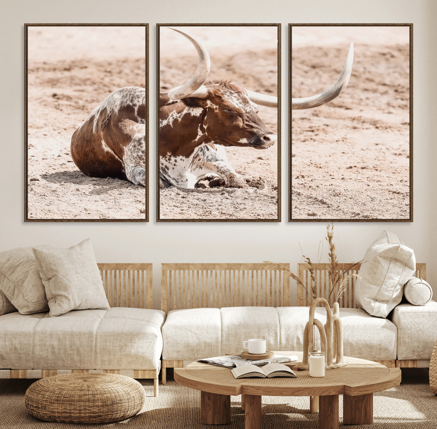 Texas Longhorn bull resting on dusty ground with warm tones, ideal for rustic western or farmhouse-themed wall decor.