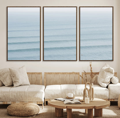 Framed canvas of repeating ocean waves with a distant solo surfer, ideal for minimalist ocean or calm coastal wall decor.