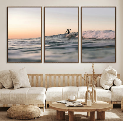 Framed canvas of a female surfer balancing on a wave at sunset, perfect for serene surf or ocean-inspired coastal decor.