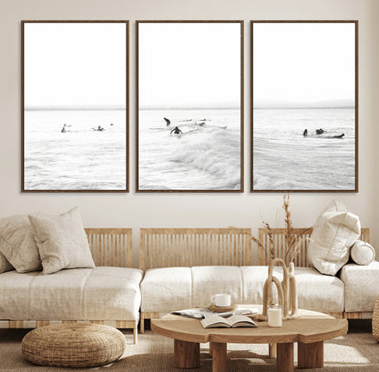 Monochrome photo of surfers riding and waiting on ocean waves, ideal for surf-themed or coastal energy wall decor.