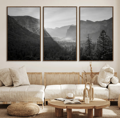 Black and white landscape of Yosemite with sun rays peeking over El Capitan, ideal for moody nature or modern rustic decor.