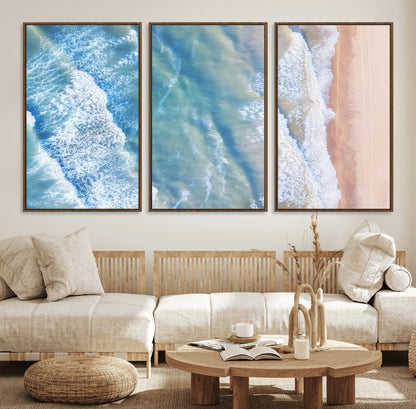 Aerial photo of soft blue waves meeting sandy shore, perfect for modern coastal or beach-themed decor with a light and tranquil aesthetic.