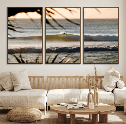Photo of a surfer riding a golden hour wave at sunset, with tropical tones and dreamy light, perfect for tropical boho or coastal home decor.