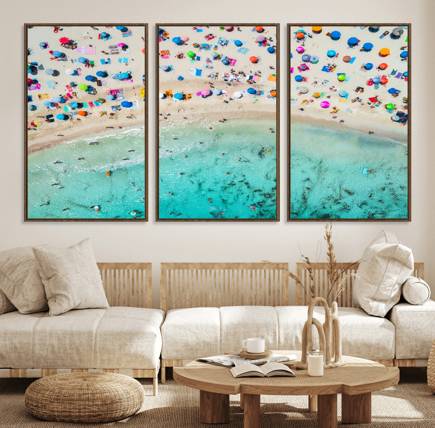 Aerial view of a vibrant beach filled with colorful umbrellas and people enjoying the turquoise ocean, capturing a lively summer vacation scene.