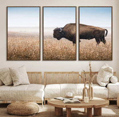 A majestic bison standing in an open prairie field, its strong form blending into the golden grass under a vast blue sky, evoking the wild spirit of the American plains.