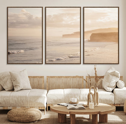 Golden hour seascape with misty cliffs and gentle waves rolling towards the shore, capturing a tranquil and warm coastal atmosphere.