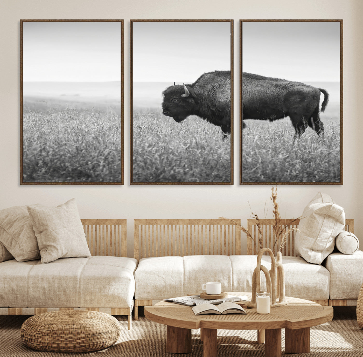 A black and white photograph of a majestic bison standing in a vast grassy prairie, evoking a sense of wilderness and strength.