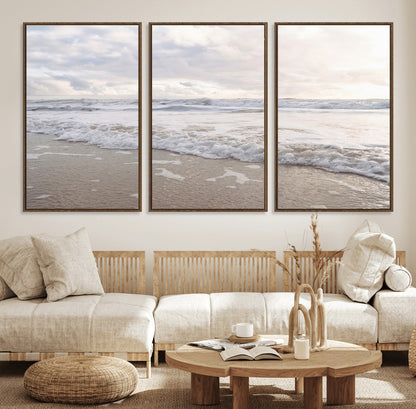 Peaceful ocean waves rolling onto the sandy shore under soft light, perfect for neutral or coastal minimalist decor themes.