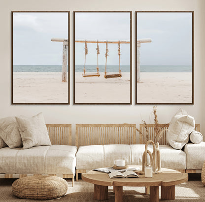 A rustic wooden beach swing stands on a serene sandy shore with an ocean horizon in the background, creating a tranquil and dreamy coastal escape.