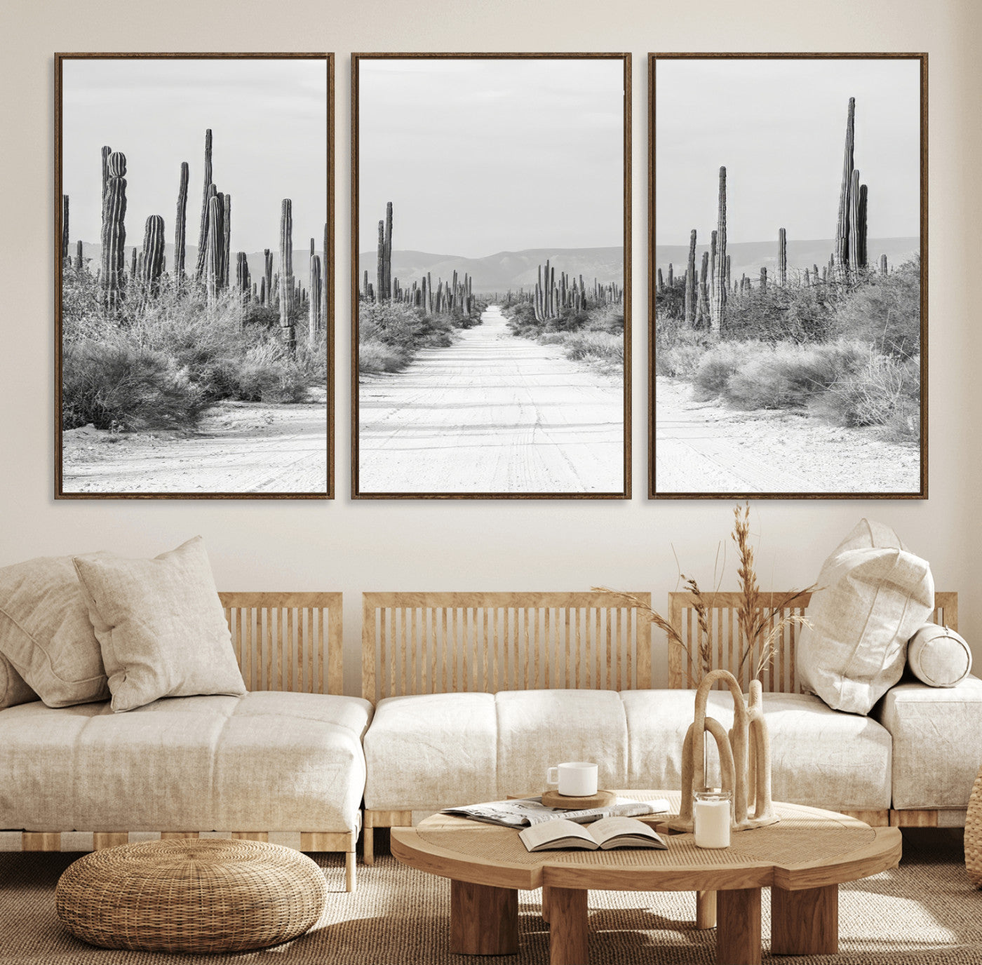 A black and white desert road stretching through a cactus-filled landscape, creating a rugged and timeless southwestern aesthetic with a sense of adventure.